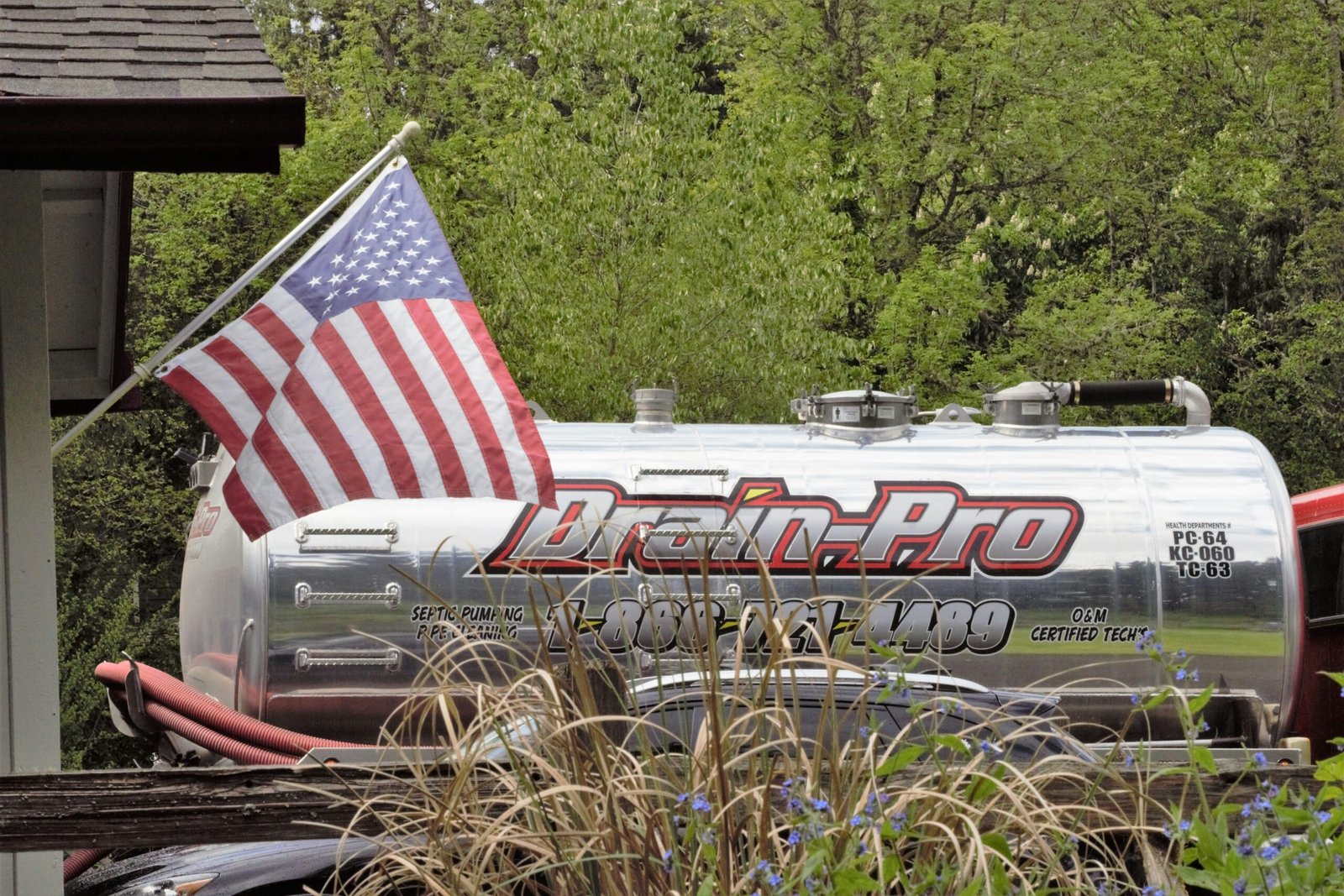 a silver tank with a flag on top of it